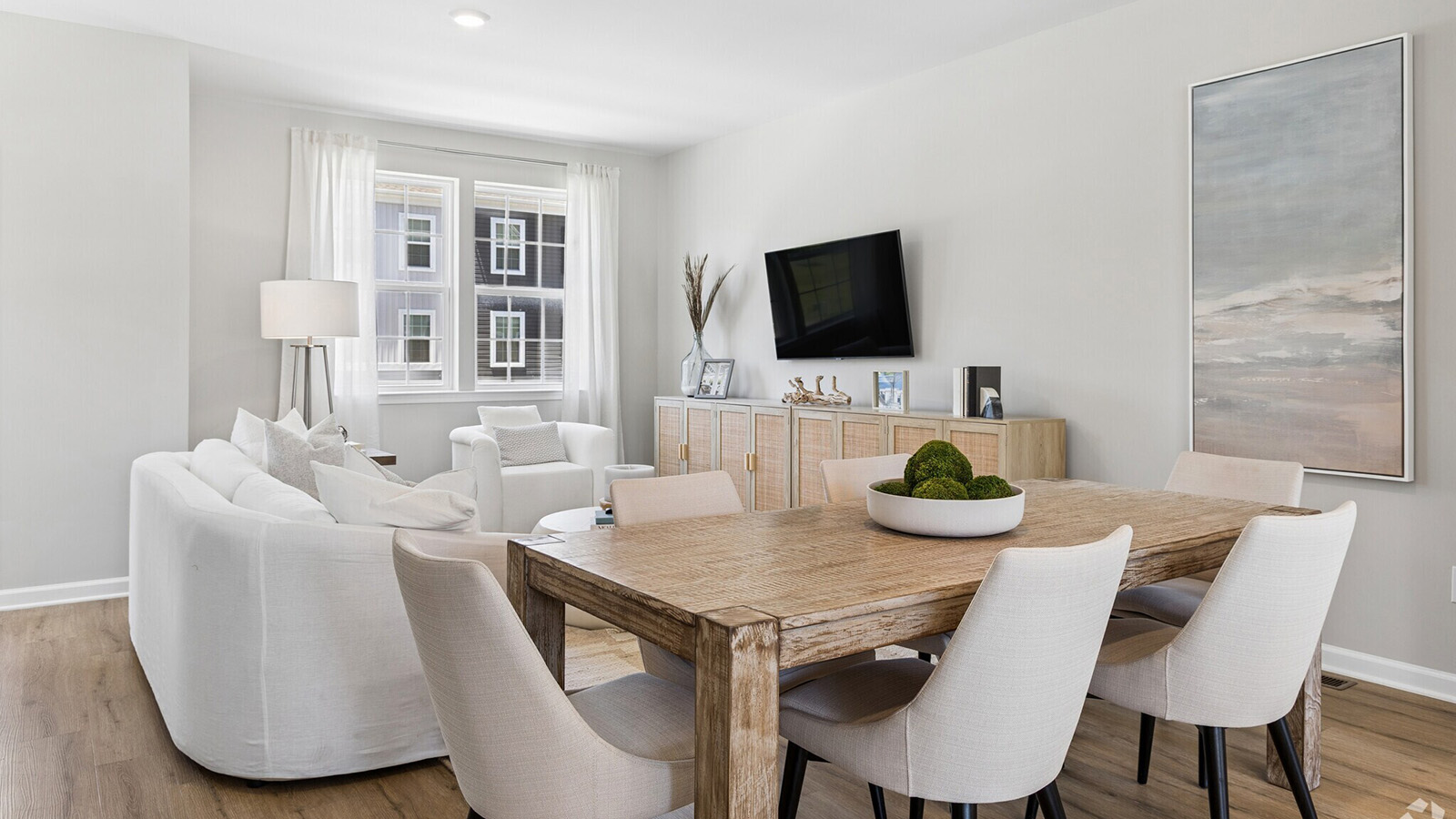 spacious main floor living featuring the dining table and living room