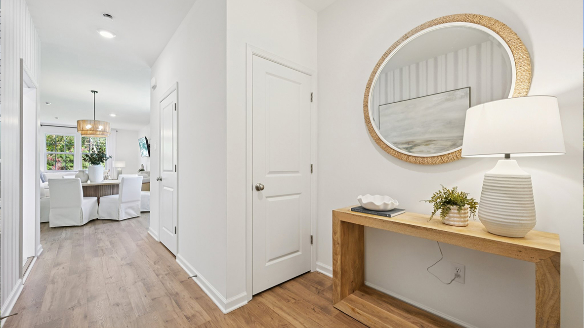 modern front entrance with gold mirror and table