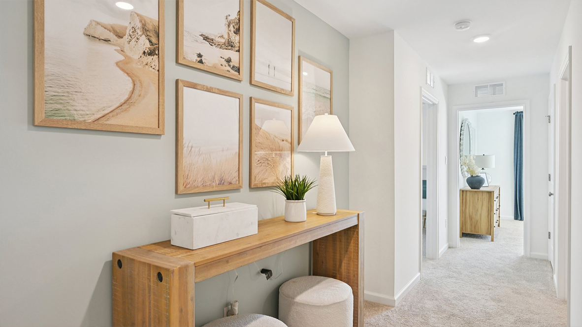 decorative stand on the second floor hall with wall art