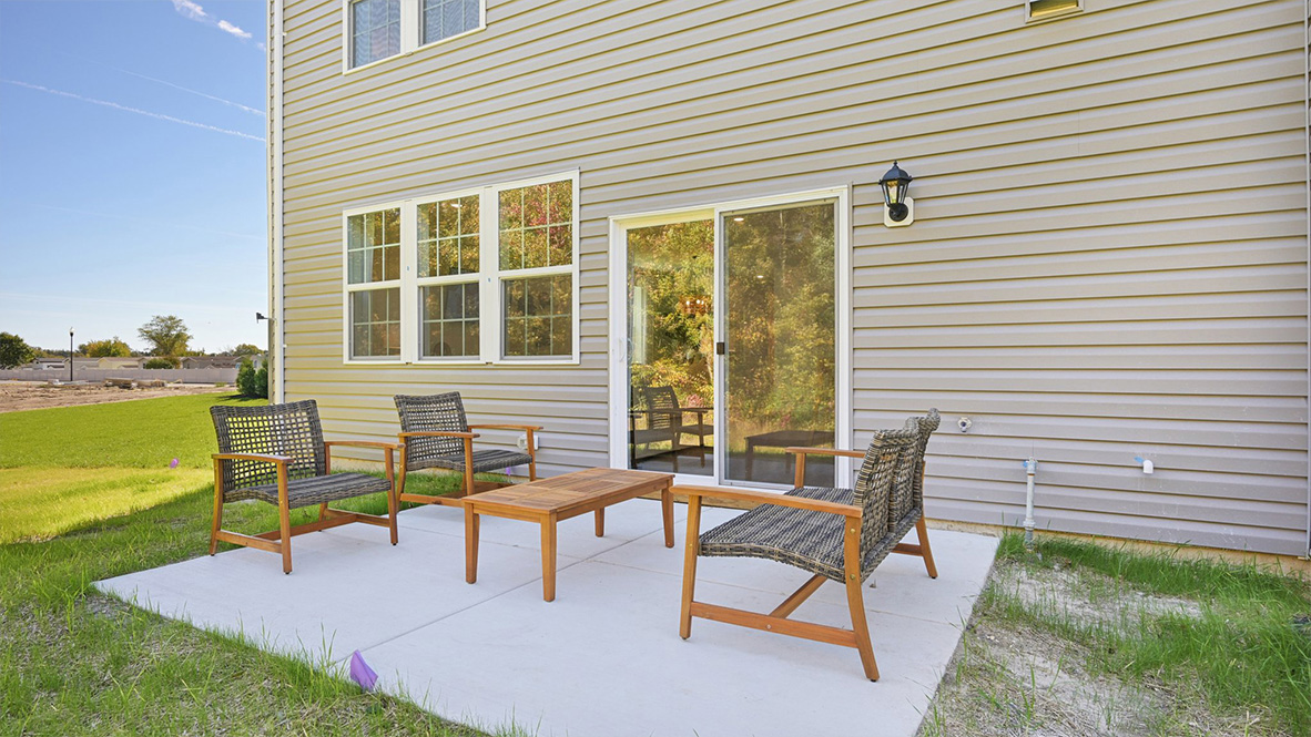 outside patio with furniture and green space