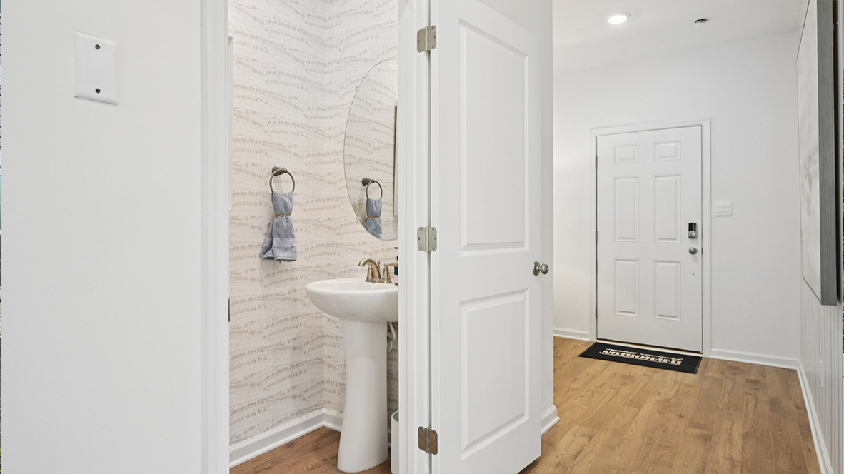 front entrance with the powder room to the left