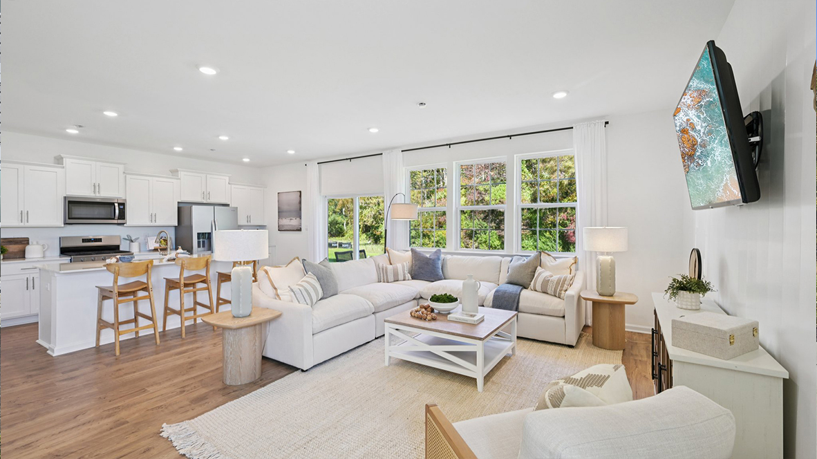 large coastal themed living room with an open concept layout