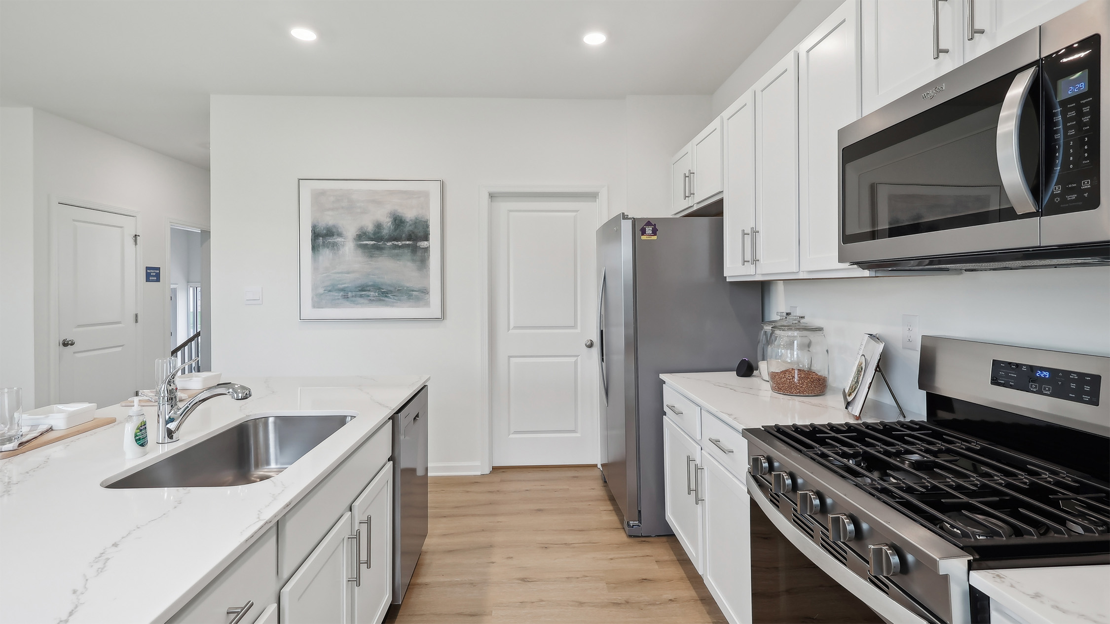 spacious kitchen with large island and white cabinetry