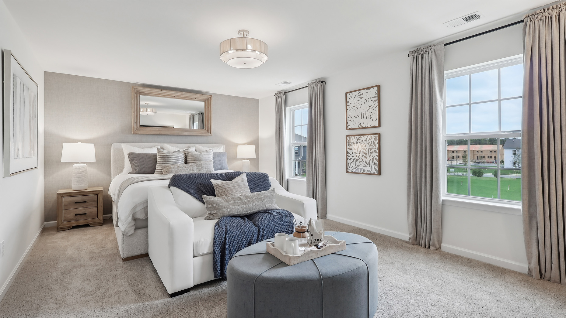 primary suite with light fixture, full bath, and large walk in closet