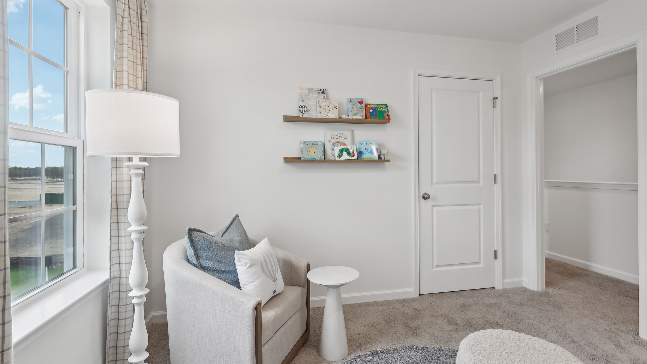 nursery with cool tones throughout and ample space