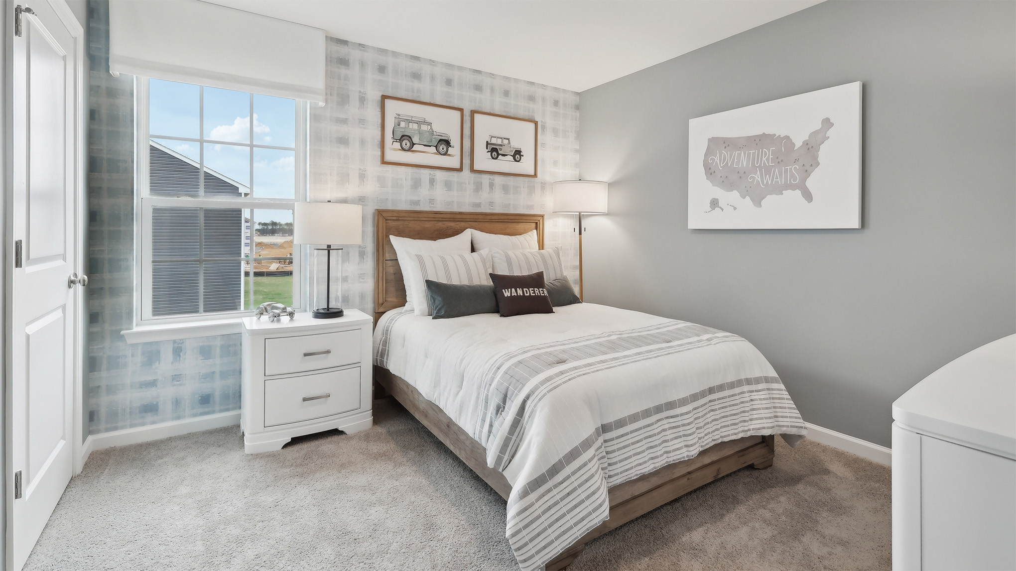 spacious bedroom with gray walls and large window