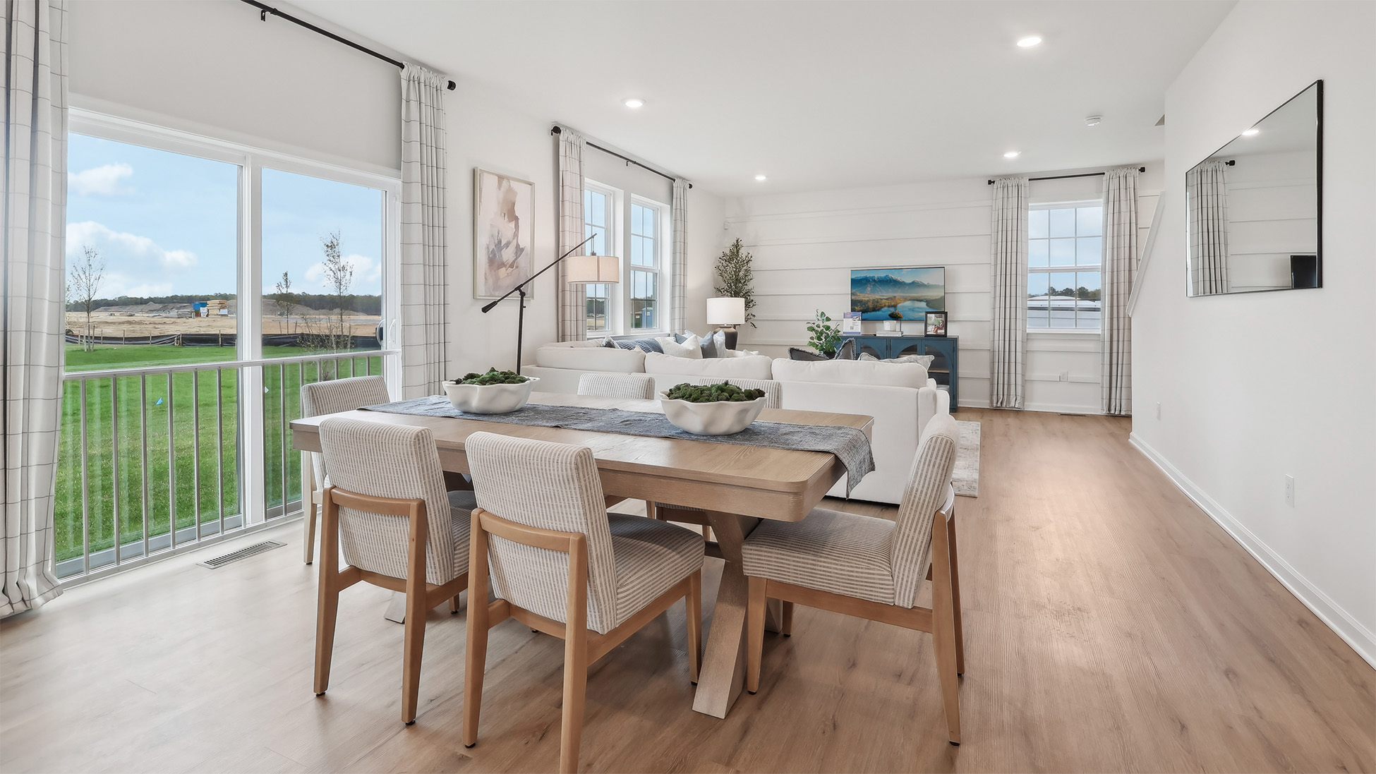 spacious main floor showcasing the dining table next to the sliding glass door to the yard