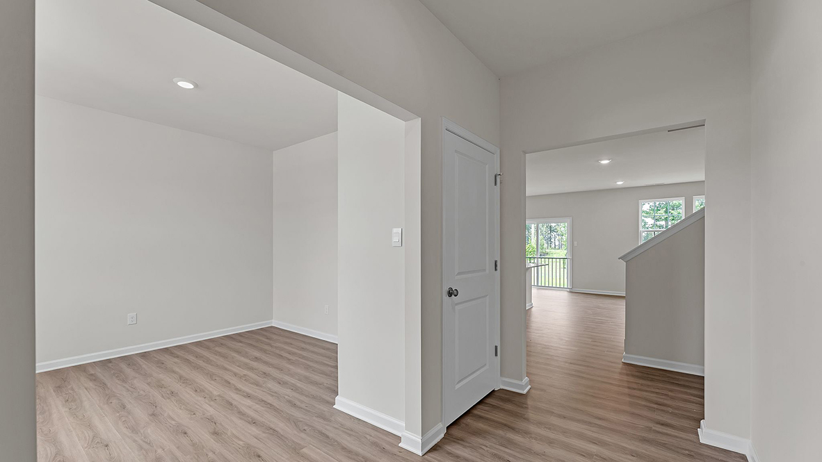 modern front entrance into the flex room, with light wood floors throughout