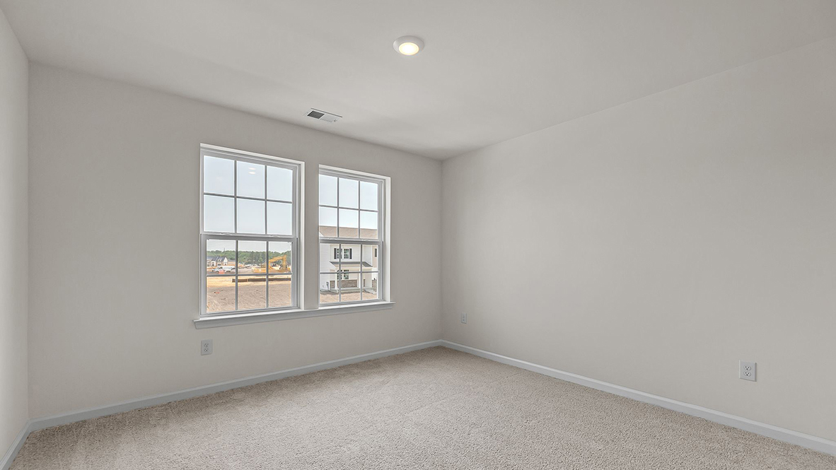 spacious bedroom with large windows