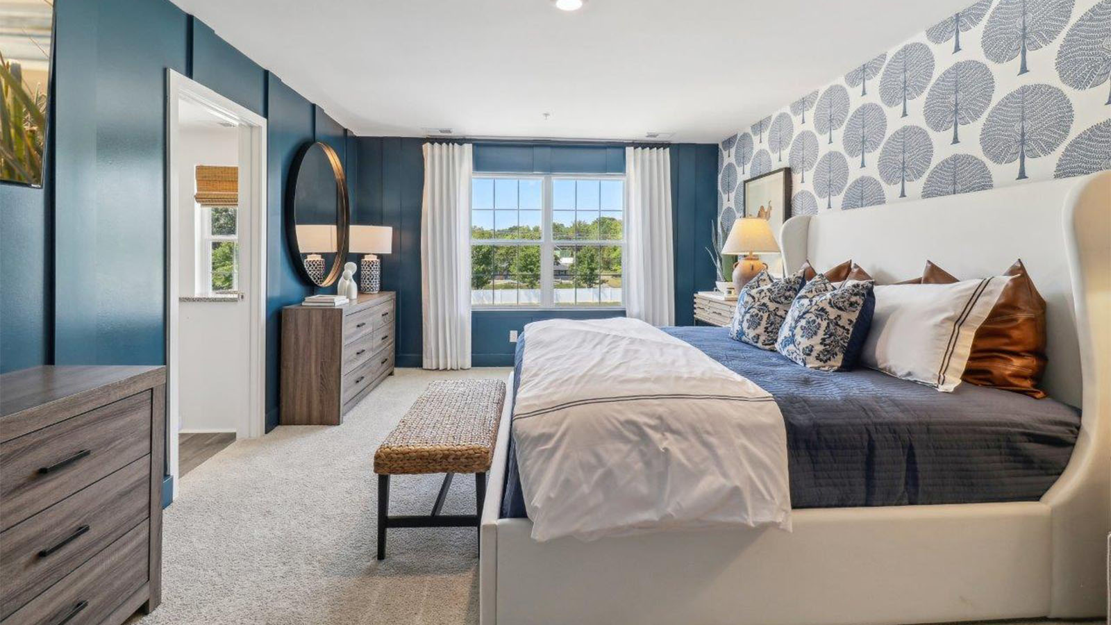 primary bedroom with modern design and large walk in closet and double vanity in full bath