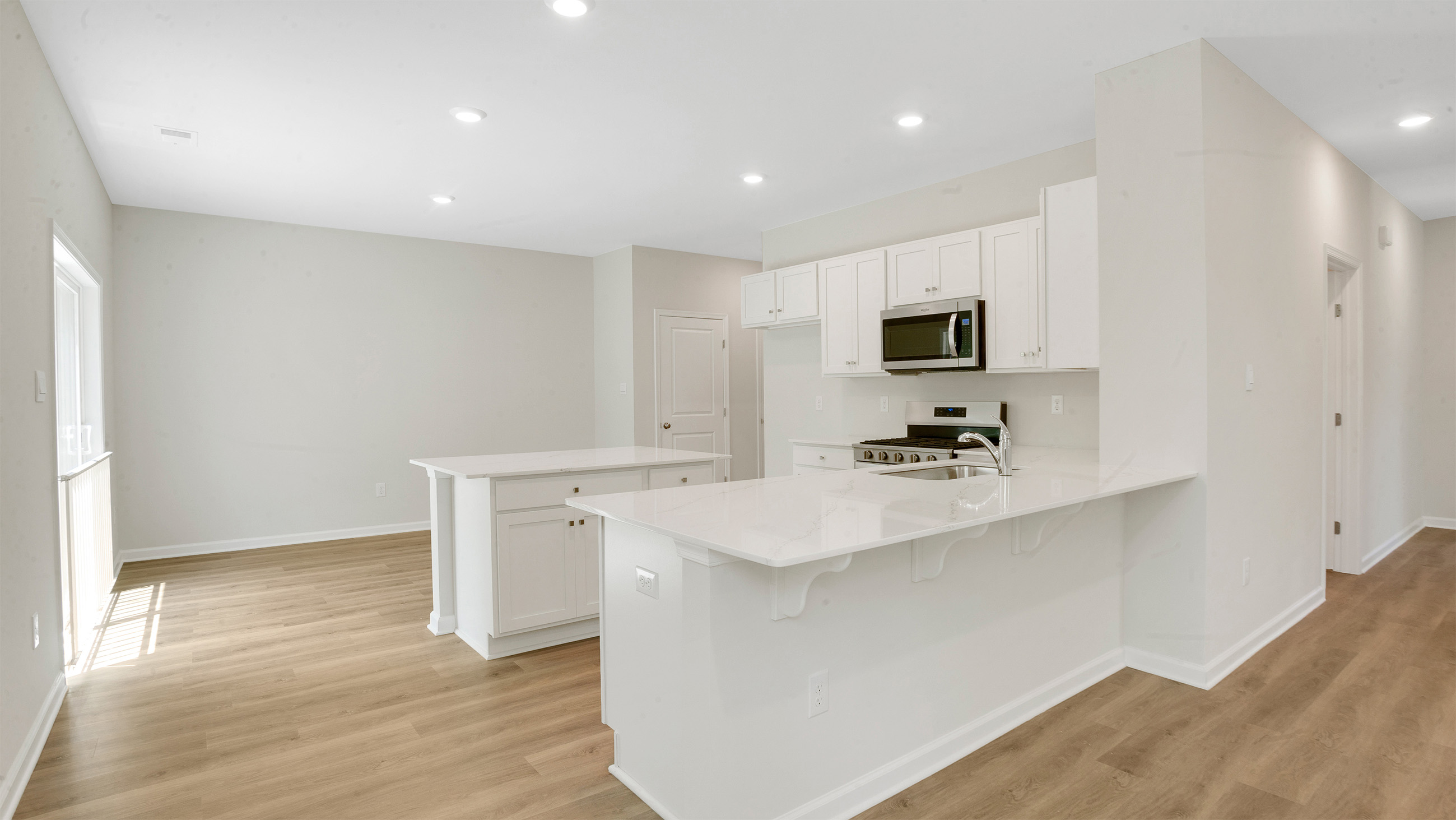 large kitchen island in a northwest model with light wood floors