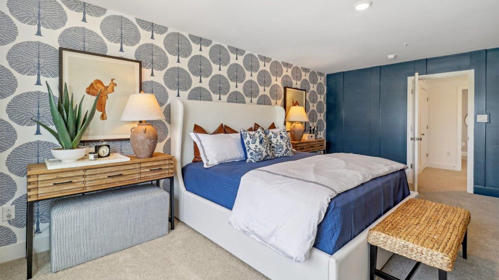 primary suite with walk in closet and full bath