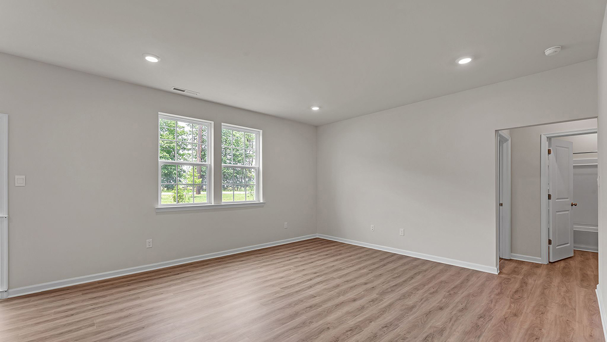 large open concept living room with spacious kitchen behind