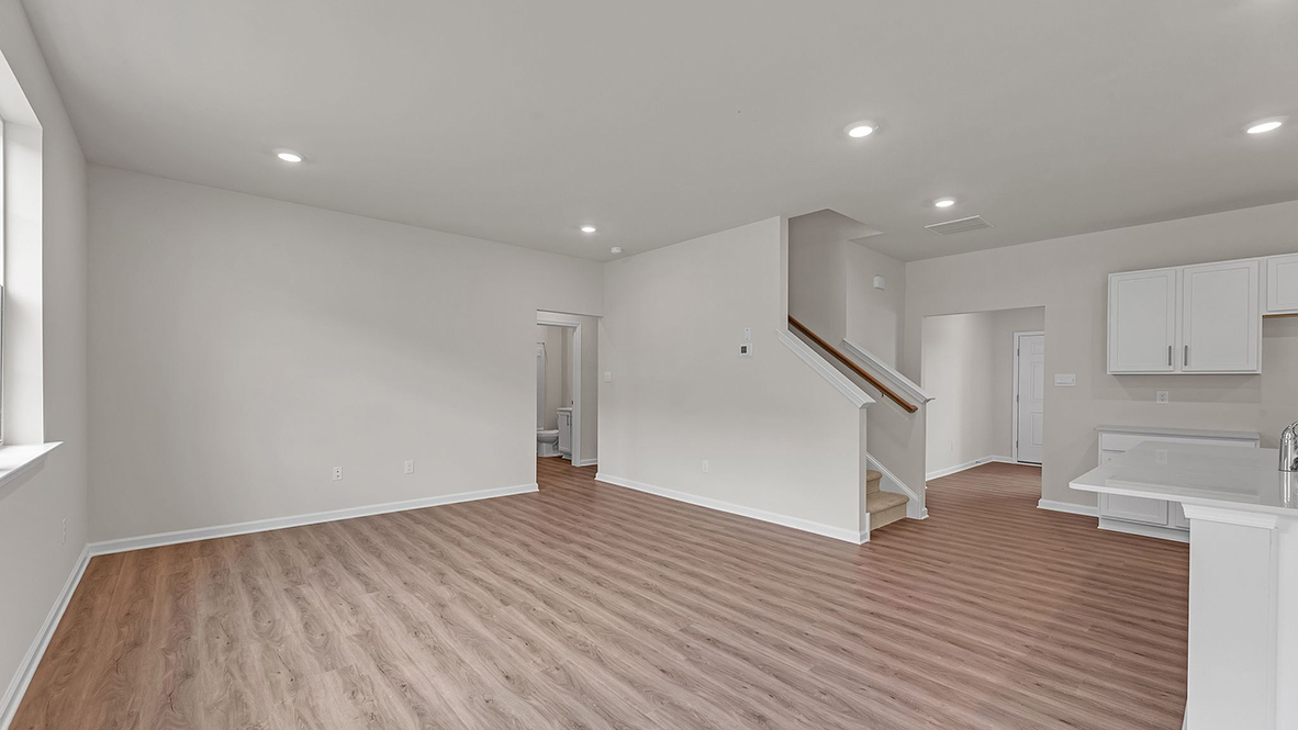 large open concept living room with spacious kitchen behind