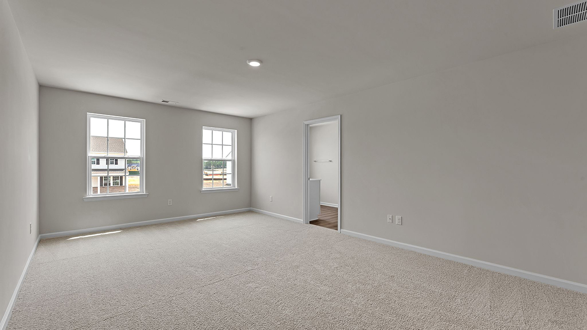 spacious bedroom with large windows and full bath