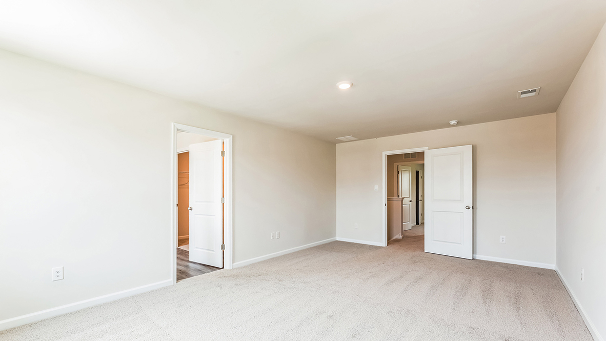 spacious bedroom with large windows and full bath