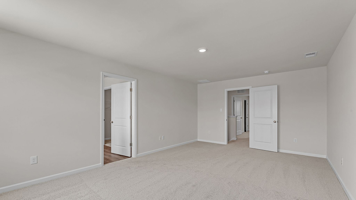 spacious bedroom with large windows and full bath