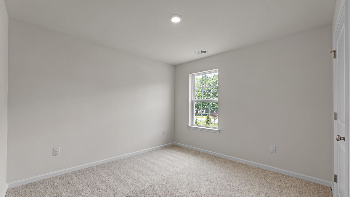 spacious bedroom with large window
