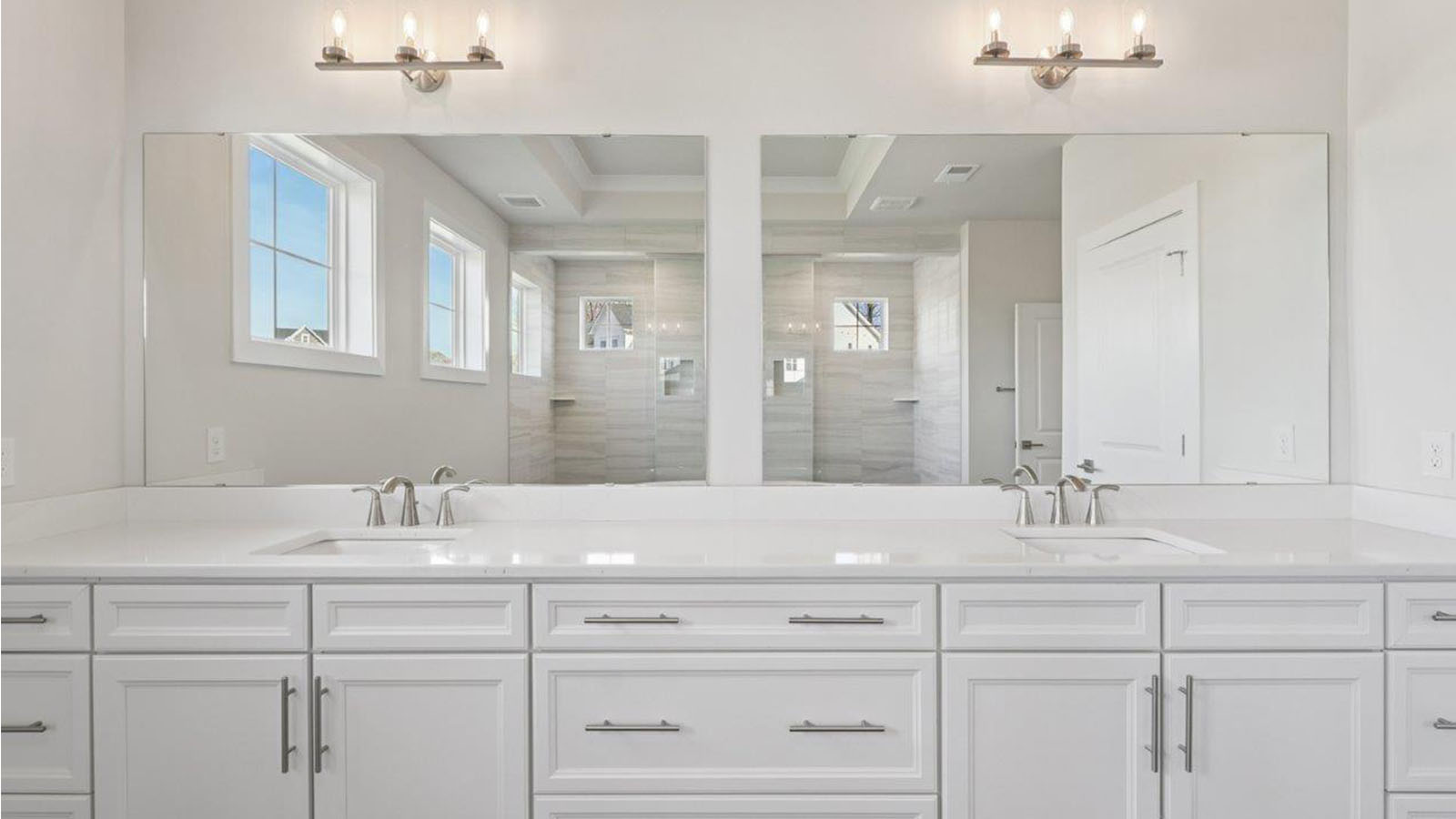 large primary suite with walk in closet and large full bathroom with double vanity, spacious shower and standing tub