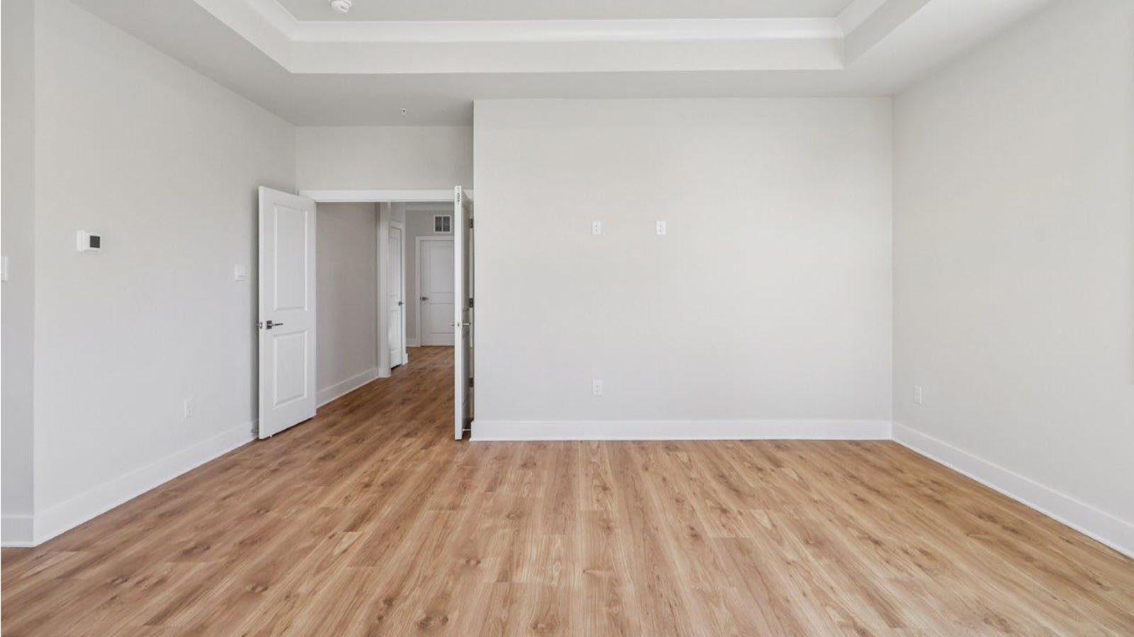 large primary suite with walk in closet and large full bathroom with double vanity, spacious shower and standing tub