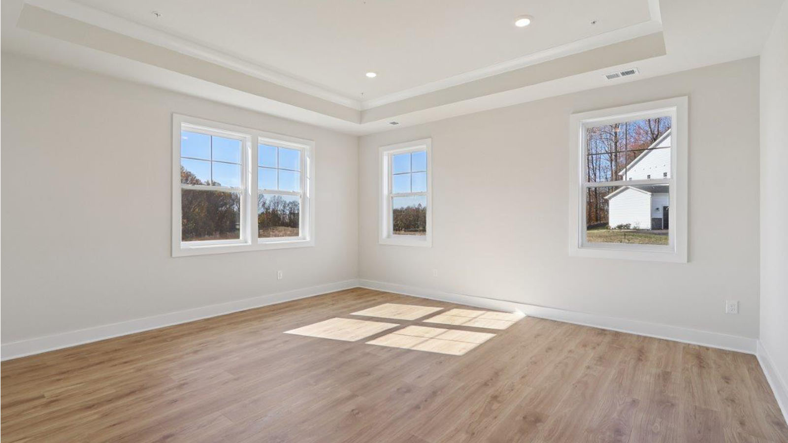 large primary suite with walk in closet and large full bathroom with double vanity, spacious shower and standing tub