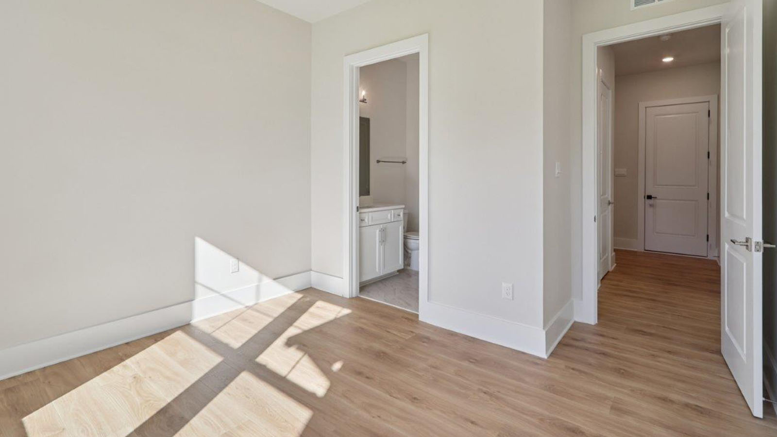 large primary suite with walk in closet and large full bathroom with double vanity, spacious shower and standing tub