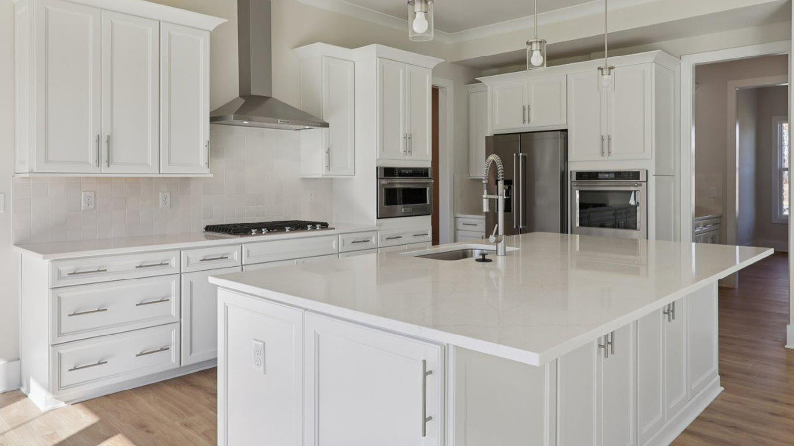 open concept living room and spacious kitchen with large island and light fixture
