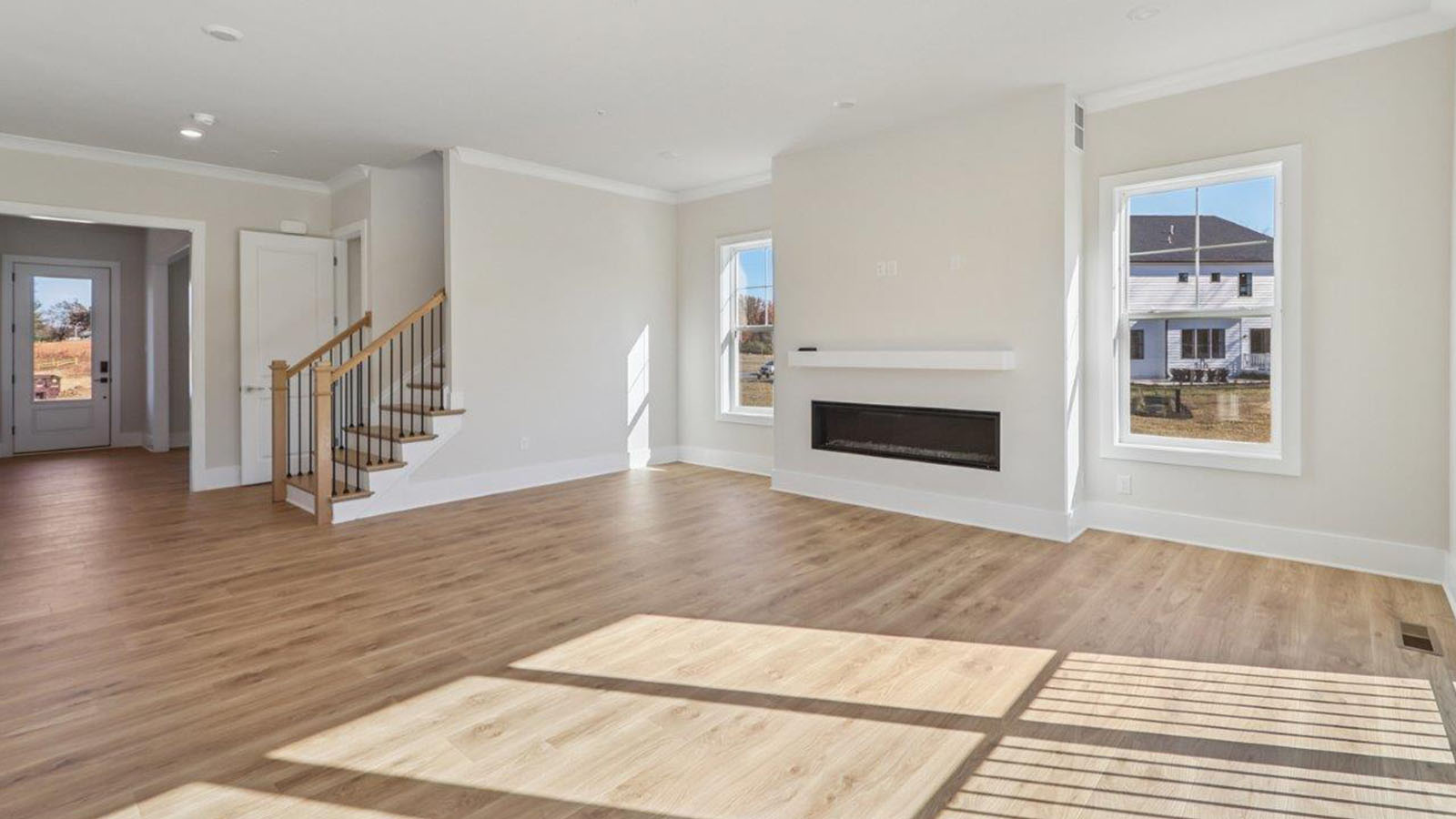 open concept living room and stairs leading to second floor