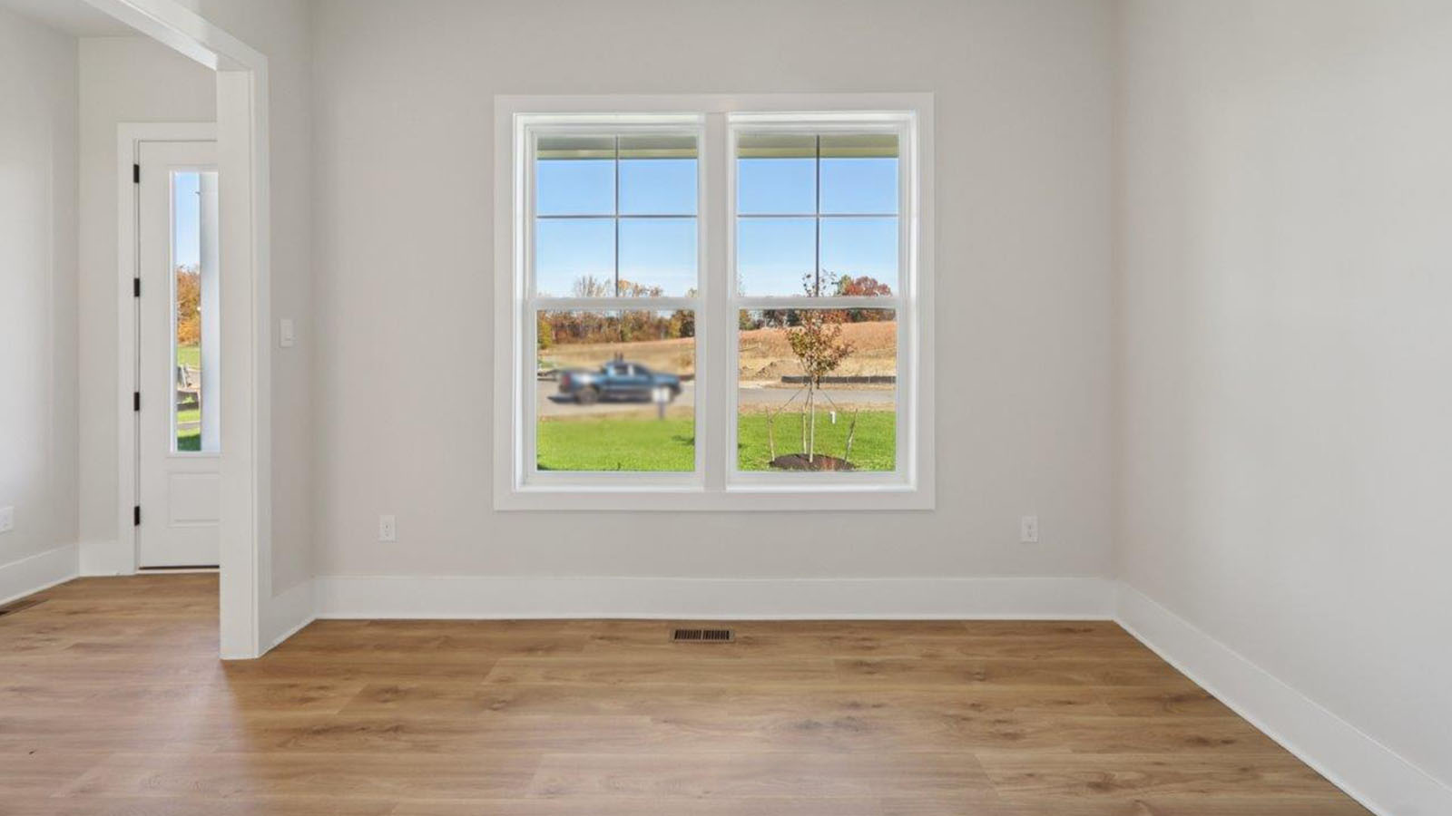 flex room with large windows off the front entrance