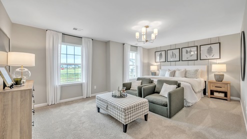 bedroom with beige carpet