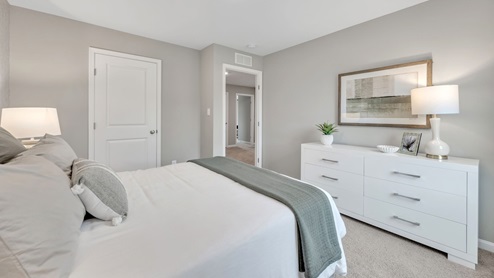 bedroom with beige carpet