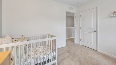 bedroom with beige carpet