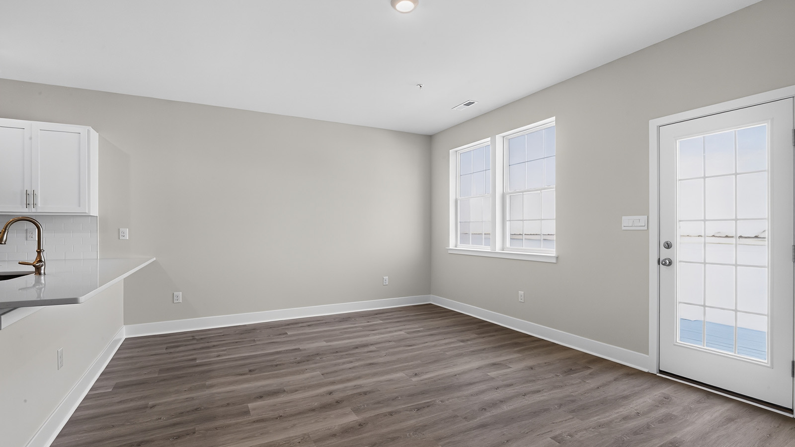 spacious open concept living room with medium toned hardwood throughout