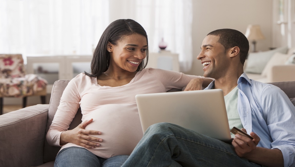 couple laughing on the couch in their new home
