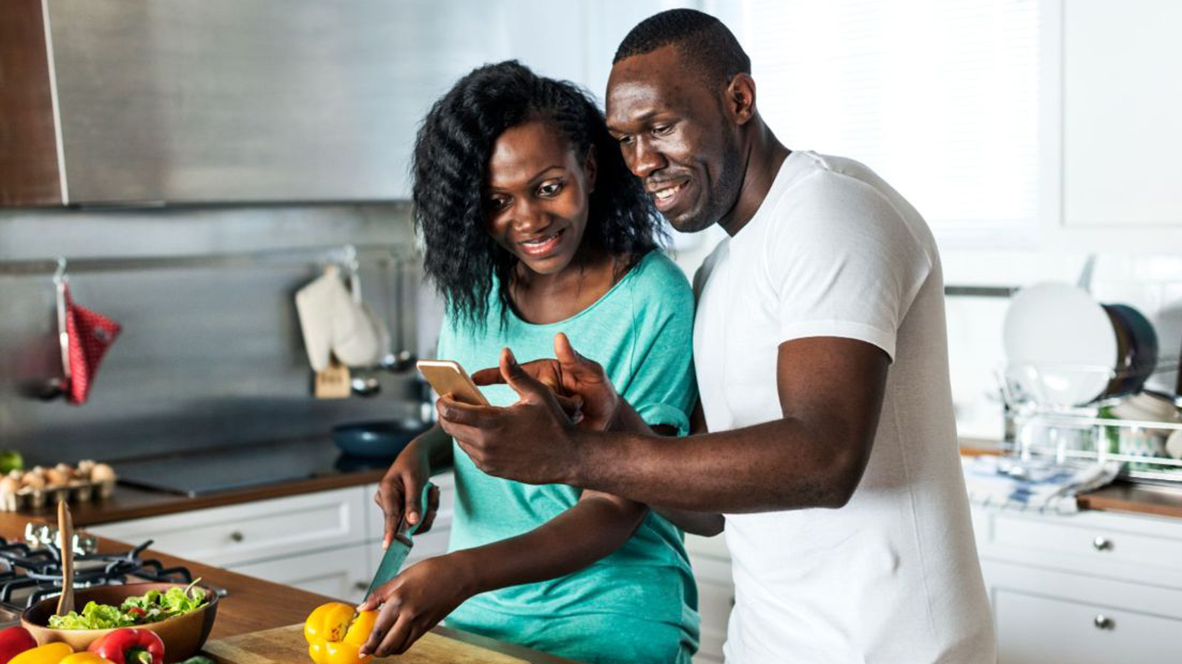 couple laughing in the kitchen
