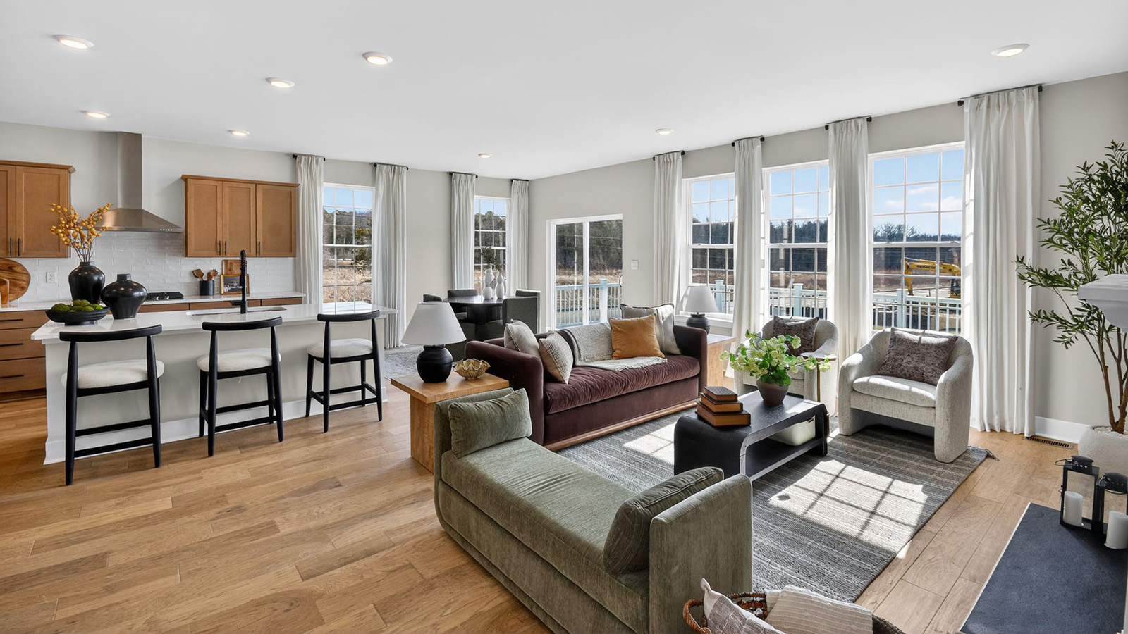 open concept living room with modern design and spacious kitchen behind
