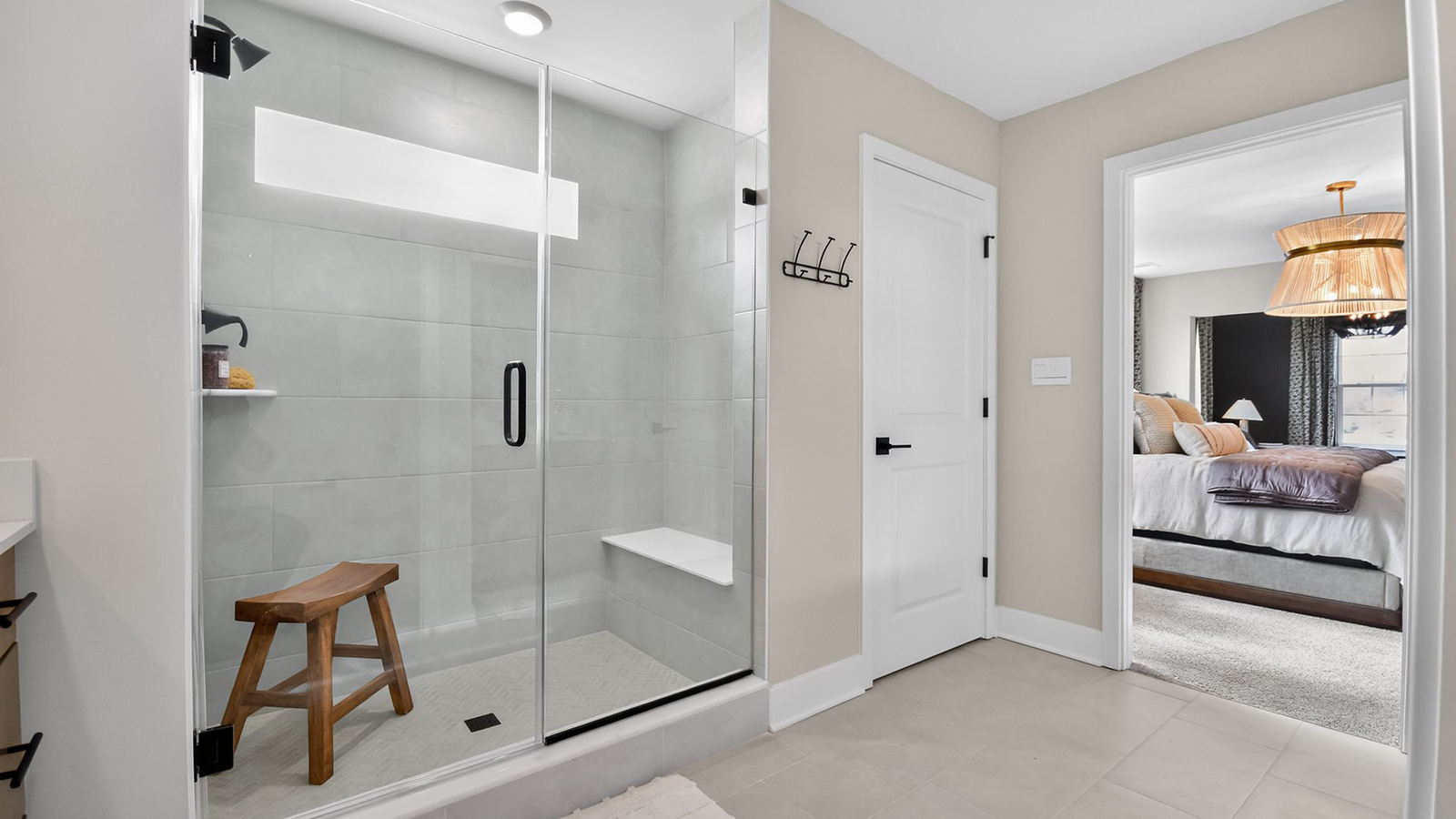 large full bath in the primary suite with spacious shower and his and hers vanity