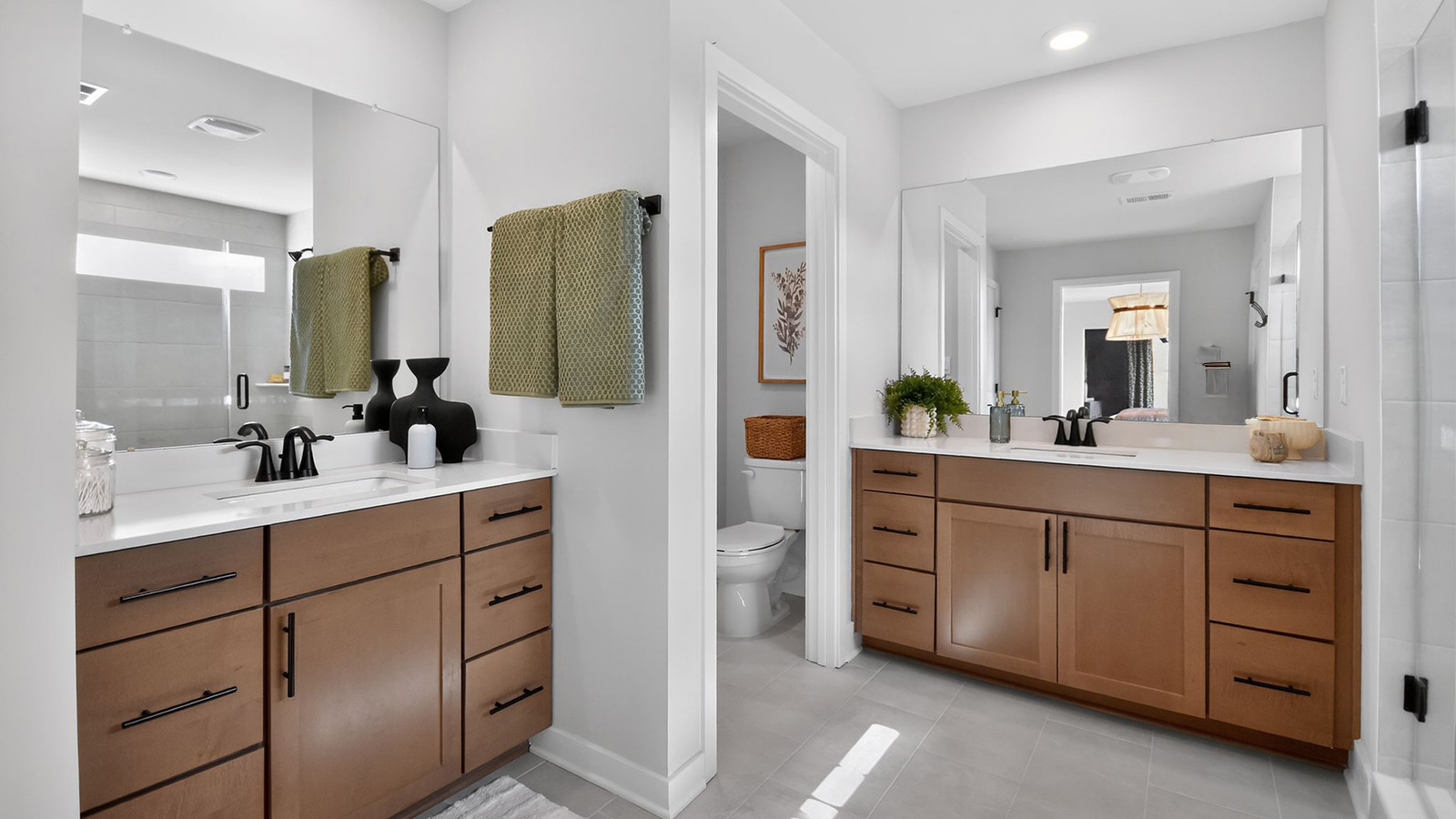 large full bath in the primary suite with spacious shower and his and hers vanity