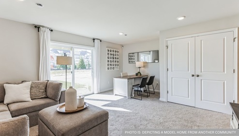 first floor flex room with beige carpet