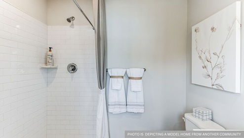 white bathroom with bathtub and shower combo