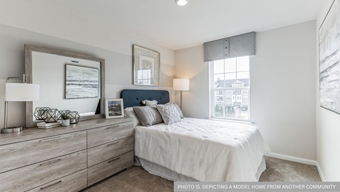 bedroom with beige carpet