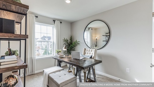 flex bedroom being utilized as a home office with beige carpet