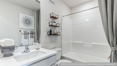 white bathroom with bathtub and shower combo
