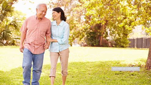 Stock photo of a middle-aged couple walking and holding hands