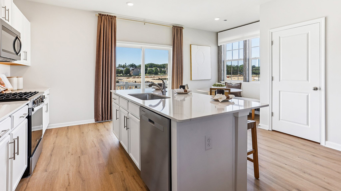 quartz island in the kitchen with white cabinetry