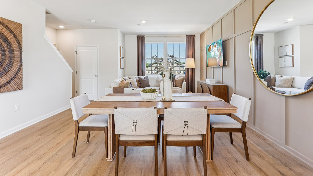 modern dining table on the main floor with feature wall