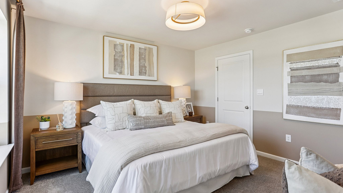 primary bedroom with large windows, a full bath, and spacious closet