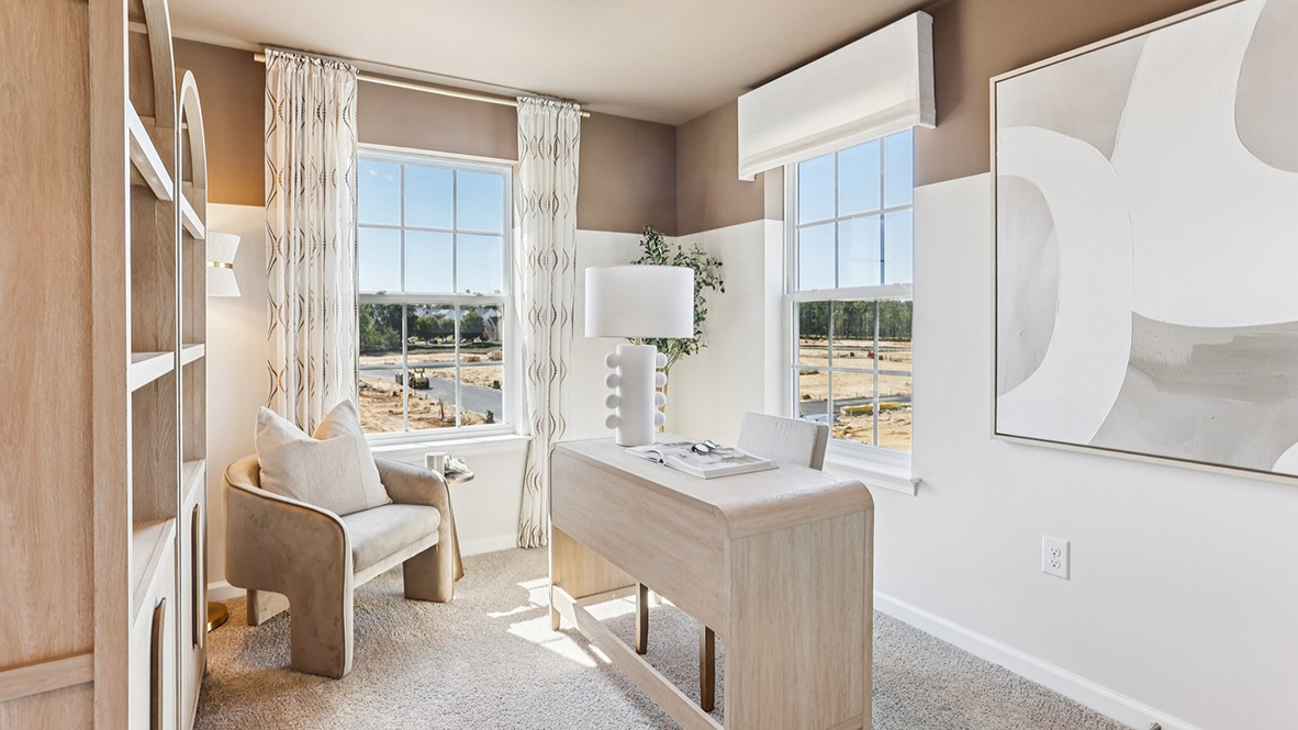 office space with large windows and light wood furniture