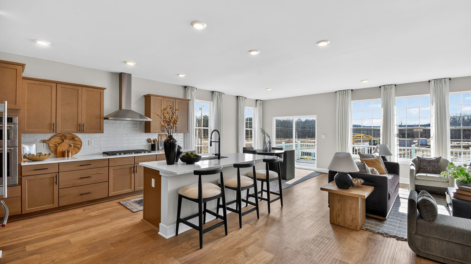 large kitchen with white quartz island and butterscotch cabinets