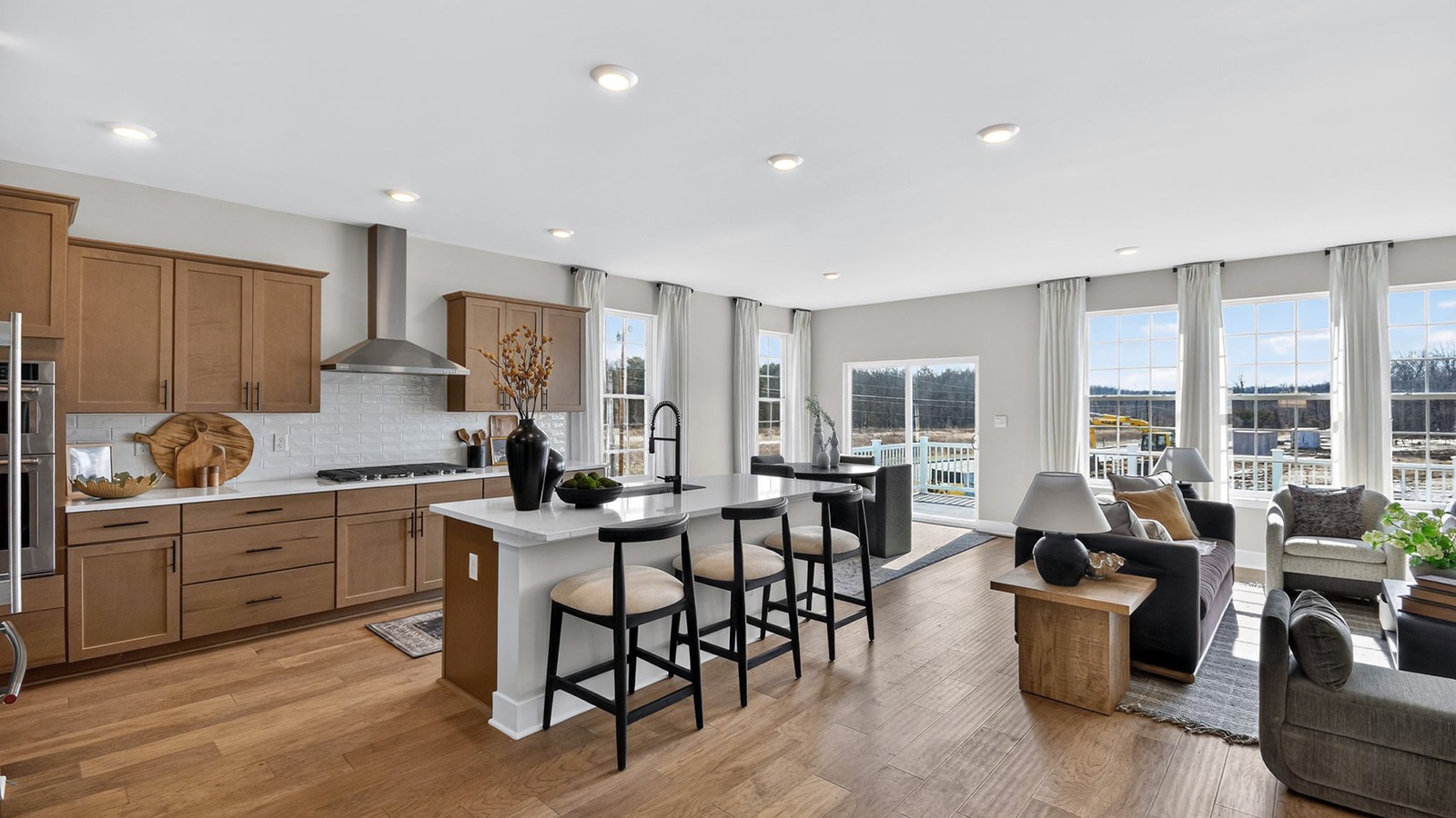 open concept living room and spacious kitchen with large quartz island